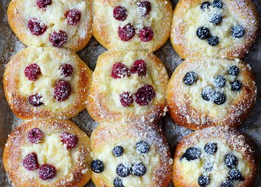 Polish sweet yeast Butter buns with vanilla pudding and berries and streusel sprinkled with powdered sugar .style hugge .top veiw.selective focus clipart