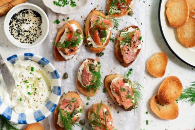 Baguette Crostini with Cream Cheese and Pink Pacific Salmon..style hugge. top veiw.selective focus clipart