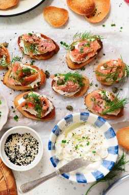 Baguette Crostini with Cream Cheese and Pink Pacific Salmon..style hugge. top veiw.selective focus clipart