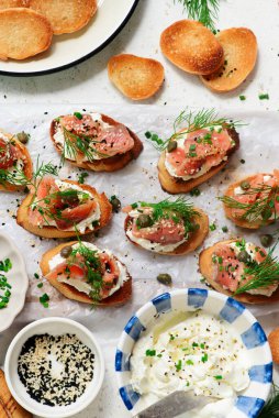 Baguette Crostini with Cream Cheese and Pink Pacific Salmon..style hugge. top veiw.selective focus clipart