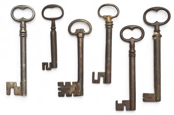 A captivating array of five antique keys, each boasting a unique, intricate design and a rich patina from years of use. The keys, laid flat, exude a sense of history and mystery.