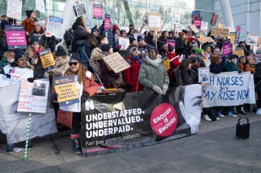 London, UK. 18th January 2023. Striking nurses with placards and banners, demonstrating outside the main entrance of University College Hospital, London, in protest to government cuts and unfair pay.