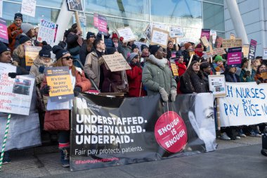 London, UK. 18th January 2023. Striking nurses with placards and banners, demonstrating outside the main entrance of University College Hospital, London, in protest to government cuts and unfair pay.