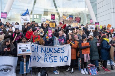 London, UK. 18th January 2023. Striking nurses with placards and banners, demonstrating outside the main entrance of University College Hospital, London, in protest to government cuts and unfair pay.