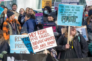 London, UK. 18th January 2023. Striking nurses with placards and banners, demonstrating outside the main entrance of University College Hospital, London, in protest to government cuts and unfair pay.