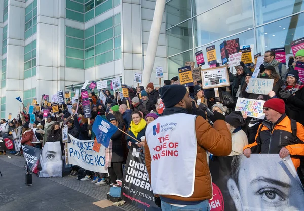 London, UK. 18th January 2023. Striking nurses with placards and banners, demonstrating outside the main entrance of University College Hospital, London, in protest to government cuts and unfair pay.