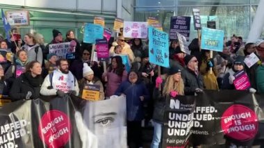 London, UK. 18th January 2023. Striking nurses with placards and banners, demonstrating outside the main entrance of University College Hospital, London, in protest to government cuts and unfair pay.