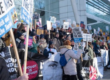 London, UK. 18th January 2023. Striking nurses with placards and banners, demonstrating outside the main entrance of University College Hospital, London, in protest to government cuts and unfair pay.