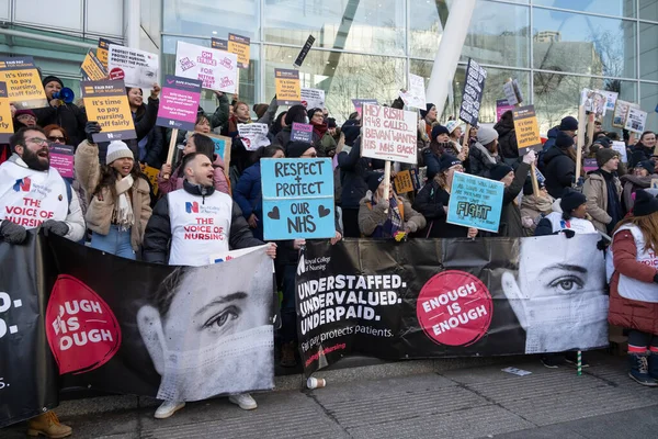 stock image London, UK. 18th January 2023. Striking nurses with placards and banners, demonstrating outside the main entrance of University College Hospital, London, in protest to government cuts and unfair pay.