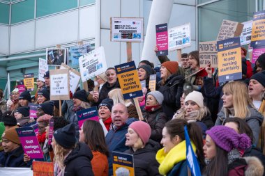 London, UK. 18th January 2023. Striking nurses with placards and banners, demonstrating outside the main entrance of University College Hospital, London, in protest to government cuts and unfair pay.