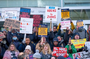 London, UK. 18th January 2023. Striking nurses with placards and banners, demonstrating outside the main entrance of University College Hospital, London, in protest to government cuts and unfair pay.