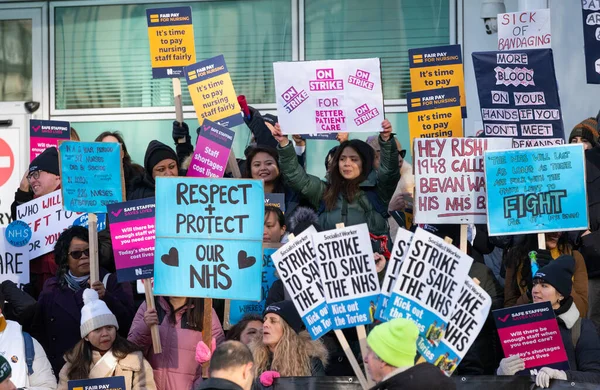 London, UK. 18th January 2023. Striking nurses with placards and banners, demonstrating outside the main entrance of University College Hospital, London, in protest to government cuts and unfair pay.