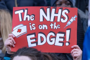 London, UK. 18th January 2023. Signs and posters waved by striking nurses, demonstrating outside the main entrance of University College Hospital, London, in protest to government cuts and unfair pay.