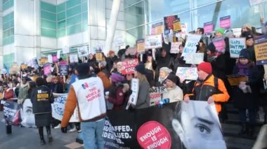 London, UK. 18th January 2023. Striking nurses with placards and banners, demonstrating outside the main entrance of University College Hospital, London, in protest to government cuts and unfair pay.