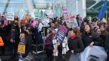 London, UK. 18th January 2023. Striking nurses with placards and banners, demonstrating outside the main entrance of University College Hospital, London, in protest to government cuts and unfair pay.