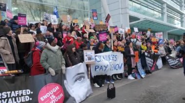 London, UK. 18th January 2023. Striking nurses with placards and banners, demonstrating outside the main entrance of University College Hospital, London, in protest to government cuts and unfair pay.