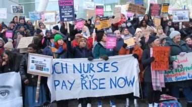 London, UK. 18th January 2023. Striking nurses with placards and banners, demonstrating outside the main entrance of University College Hospital, London, in protest to government cuts and unfair pay.