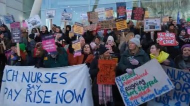 London, UK. 18th January 2023. Striking nurses with placards and banners, demonstrating outside the main entrance of University College Hospital, London, in protest to government cuts and unfair pay.