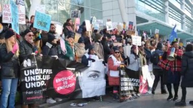 London, UK. 18th January 2023. Striking nurses with placards and banners, demonstrating outside the main entrance of University College Hospital, London, in protest to government cuts and unfair pay.