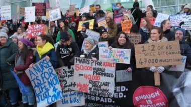 London, UK. 18th January 2023. Striking nurses with placards and banners, demonstrating outside the main entrance of University College Hospital, London, in protest to government cuts and unfair pay.