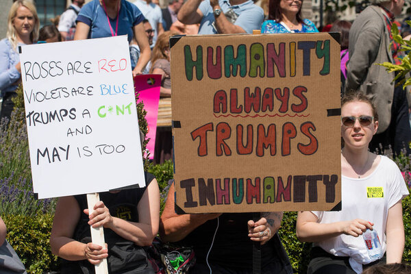 London, UK. 13th July 2018. Protesters holding up campaign posters and placards, at the #BringTheNoise Women's March Anti Donald Trump protest demonstration through the streets of central London, UK.