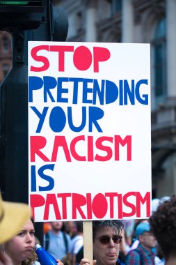 London, UK. 13th July 2018. Protester holding an anti Donald Trump protest sign, at the #BringTheNoise Women's March in protest of the US president's controversial visit to the UK and show resistance to his misogyny and racism. clipart