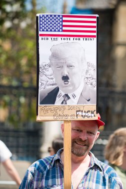 London, UK. 13th July 2018. Protester holding an anti Donald Trump protest sign, at the #BringTheNoise Women's March in protest of the US president's controversial visit to the UK and show resistance to his misogyny and racism. clipart