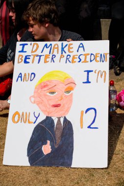 London, UK. 13th July 2018. Protester holding an anti Donald Trump protest sign, at the #BringTheNoise Women's March in protest of the US president's controversial visit to the UK and show resistance to his misogyny and racism. clipart