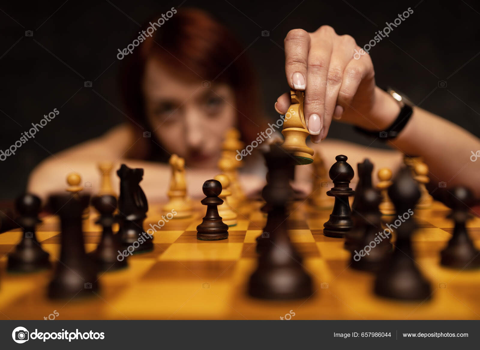 Download A Person Is Playing Chess On A Board Wallpaper