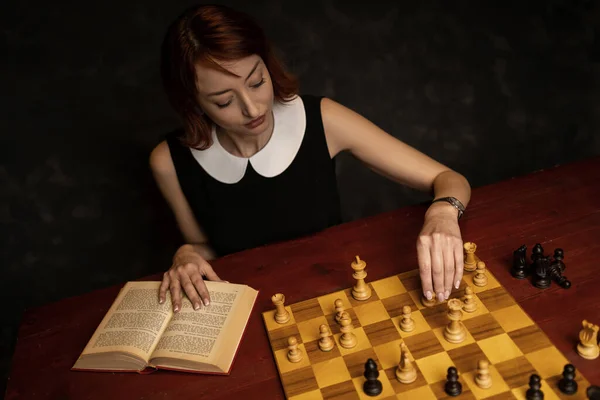 Woman Studying Chess Manual Dark Background Holding King Piece — Stock Photo, Image