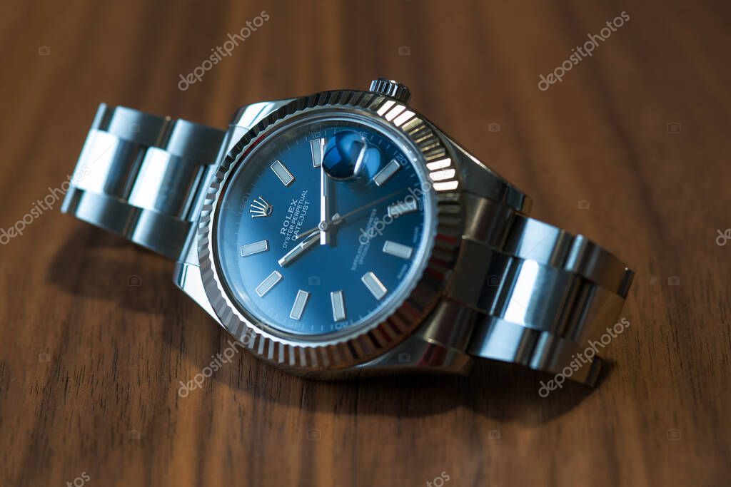 BOLOGNA, ITALY - DECEMBER, 2018: Rolex Datejust watch on wooden table. Rolex SA is a Swiss luxury watchmaker, founded in London, England in 1905. Illustrative editorial.
