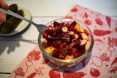 Vinaigrette salad on the fork. 