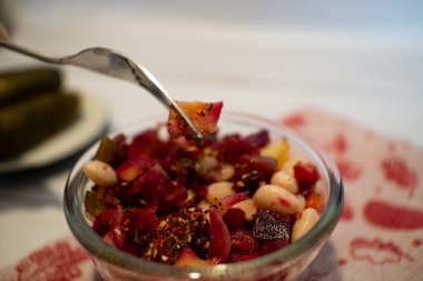 Vinaigrette salad on the fork. 