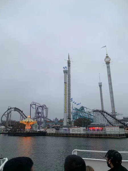 view of an amusement park Grnalund in Stockholm, Sweden. carousel view from a ship, from water in early evening