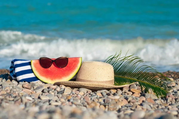 Hat Sunglasses Watermelon Tropical Leaf Towel Laying Stony Beach Blue — Zdjęcie stockowe