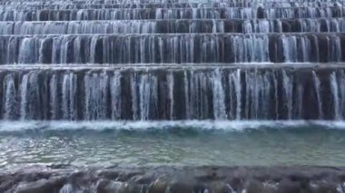 Man made beautiful large waterfall with many stairs. Aerial drone view. Horizontal video. Close up cascade.