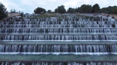 Man made beautiful large waterfall with many stairs. Aerial drone view. Horizontal video. Cascade from top view. 