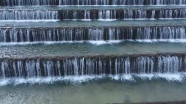 Man made beautiful large waterfall with many stairs. Aerial drone view. Horizontal video. Cascade from top view. 
