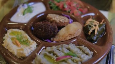 Mısır yemeği masanın üzerindedir. Arap mutfağına yakın çekim. Odaklanma yavaş yavaş değişiyor. Bir restoranda tandır roti ekmeği. 