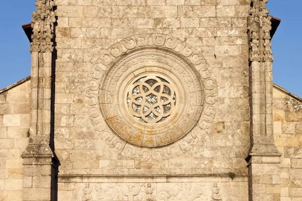 Rosette window in the facade of the medieval Main Church of Our Lady of the Assumption in Caminha, Portugal.