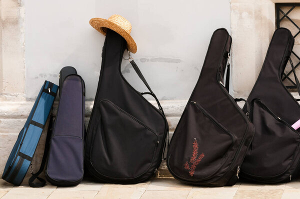 Bandura musical instruments in black cases in a row and a hat, Ukraine