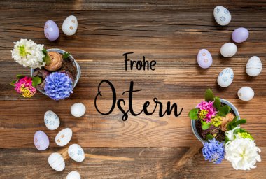 Easter Flat Lay With German Text Frohe Ostern Means Happy Easter. Flowers With Easter Egg Decoration And Ornament. Hyacinth Flower Arrangement With Wooden, Vintage Background.
