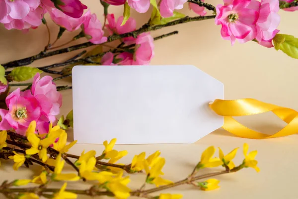 Spring Flower Arrangement With White Label With Copy Space For Free Text. Colorful Flower Branch Decoration With Yellow And Purple Blossoms.