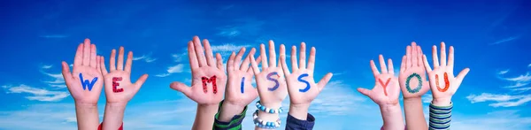 Children Hands Building Colorful English Word We Miss You. Blue Sky As Background