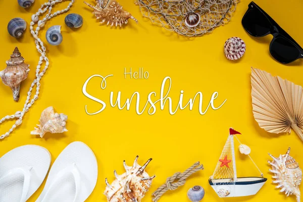 Flat Lay With English Text Hello Sunshine. Yellow Background With Summer And Maritime Accessories Like Shells, Boat, Sunglasses and Ropes.