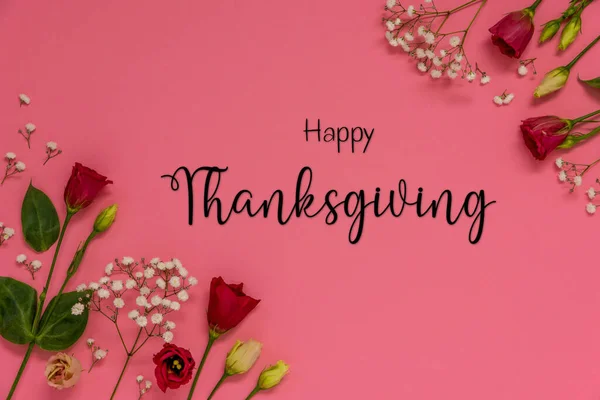 Red Roses And Flowers Arrangement With English Text Happy Thanksgiving. Pink Background And Flat Lay.
