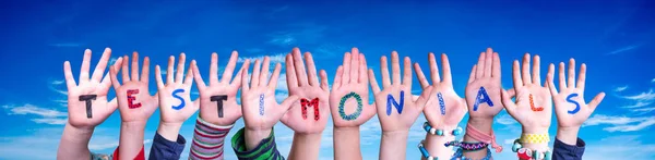 Children Hands Building Colorful English Word Testimonials Blue Sky Background — Stock Photo, Image