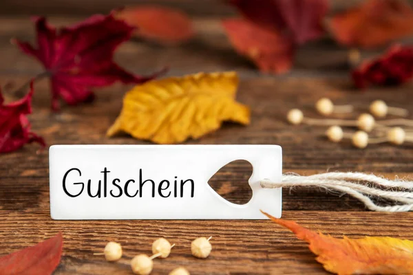 秋または秋ドイツ語のテキストGutscheinとラベル付き背景 英語でバウチャーを意味します カラフルな秋の葉 引用と季節の背景 — ストック写真