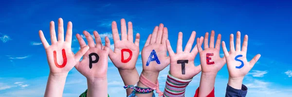 Children Hands Building Colorful English Word Updates Blue Sky Background — Stock Photo, Image