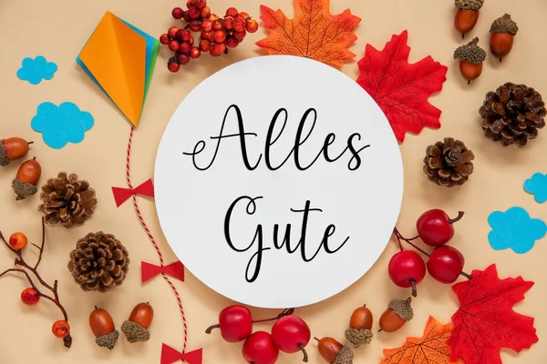 Fall Decoration, Colorful Autumn Leaves and Handicraft Kite, Round Label With German Text Alles Gute, Which Means Best Wishes in English